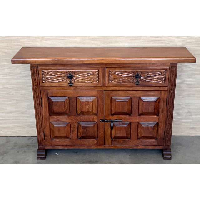 From Northern Spain, constructed of solid walnut, the rectangular top with molded edge atop a conforming case housing two...