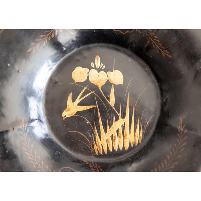 An antique 19th-Century English black lacquered papier mache lotus shaped dish or lobed tray with a handpainted...