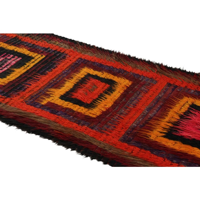 Hand-knotted in wool and originating from Turkey circa 1950-1960, this 3x9 vintage Tulu runner rug is an extremely rare...