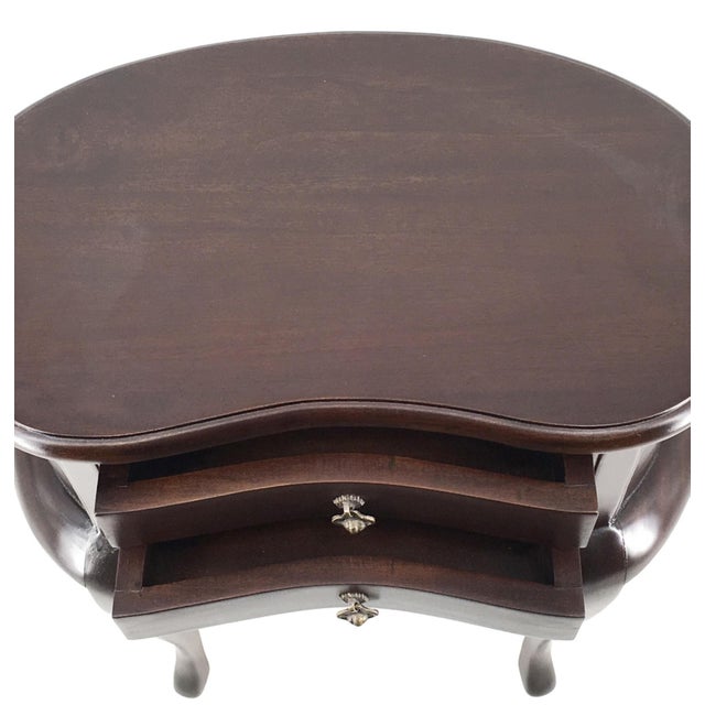 20th century pair of mahogany nightstands with kidney shape and two drawers.