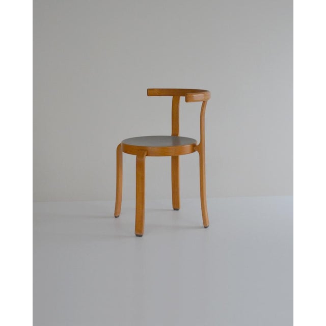 Magnus Olesen 8000 series chair. Beechwood frame; grey linoleum seat. A remarkable feature of these chairs is that they...