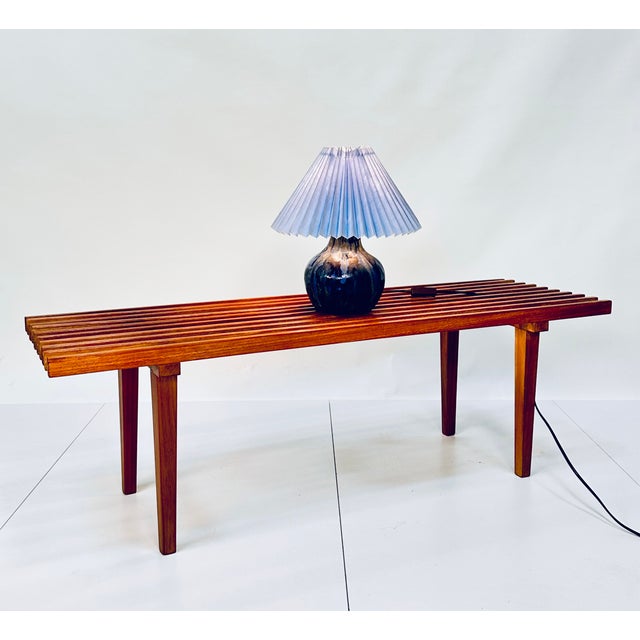 A fine studio ceramic table lamp with pleated lampshade, glazed in impressive hues of blue. The beautiful piece was hand-...