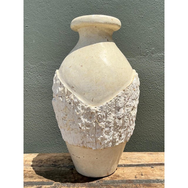 A vintage tessellated cast stone floor vase distinguished by its sculptural form and timeless classical influence....