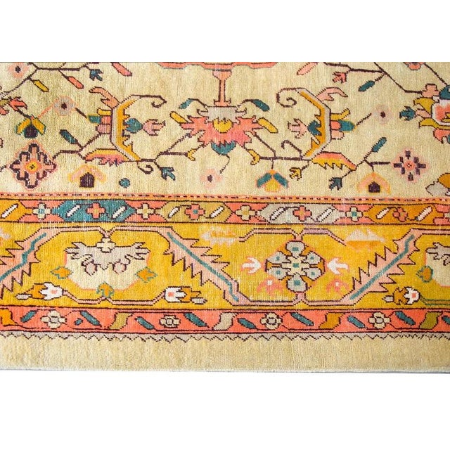 A remarkable early 20th century Turkish Oushak rug with a fabulous central medallion with a stylized floral cross, living...