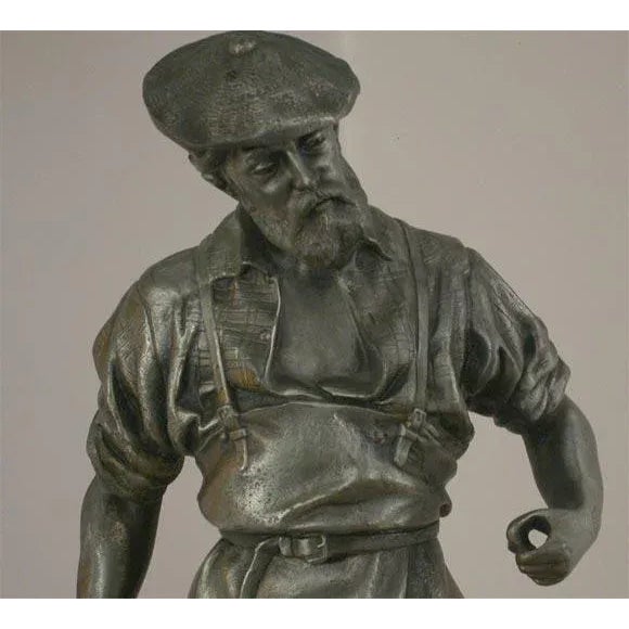 A rugged and manly fixture fit to give light and add atmosphere to many a den or office. The figure is boldly cast in his...