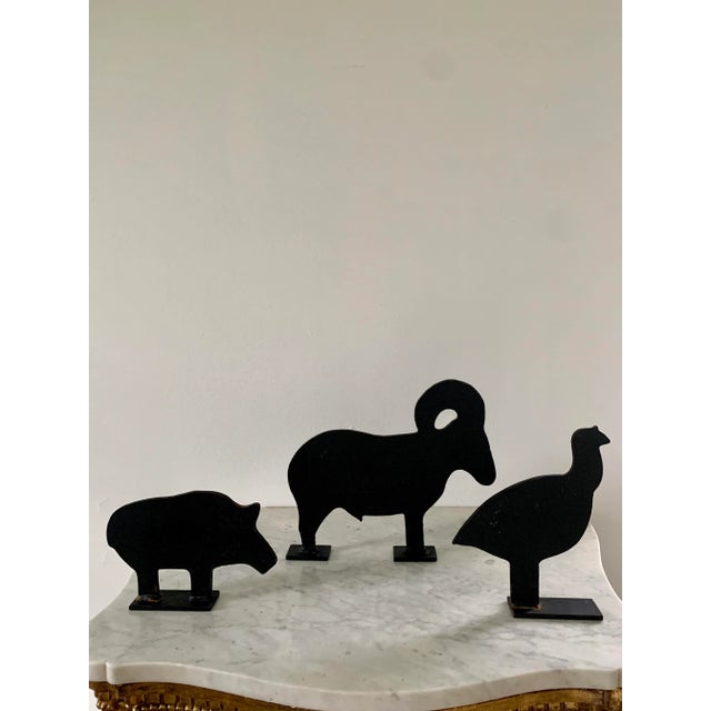 A charming set of three farmhouse country cast iron door stops or garden art in the form of a ram, pig, and quail. USA,...