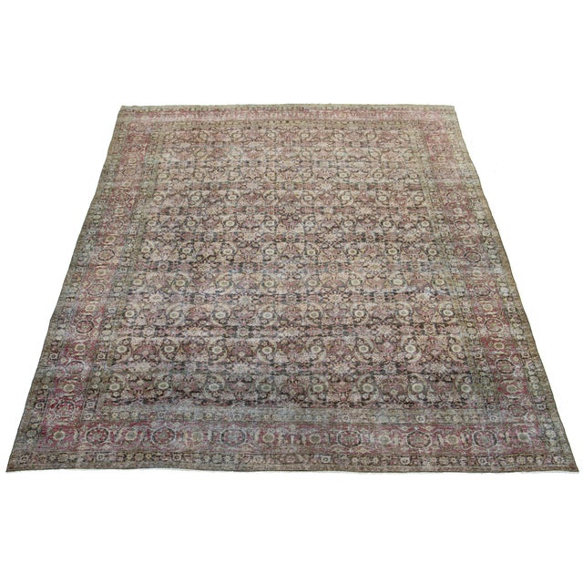 This antique Malayer hand-knotted distressed wool rug features a brown field, complemented by an exquisite all-over...