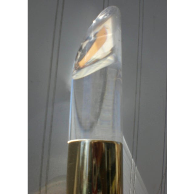 Mid-Century brass lamp with three vertical arms and Lucite caps. Shades can be pointed to the wall for softer room light....