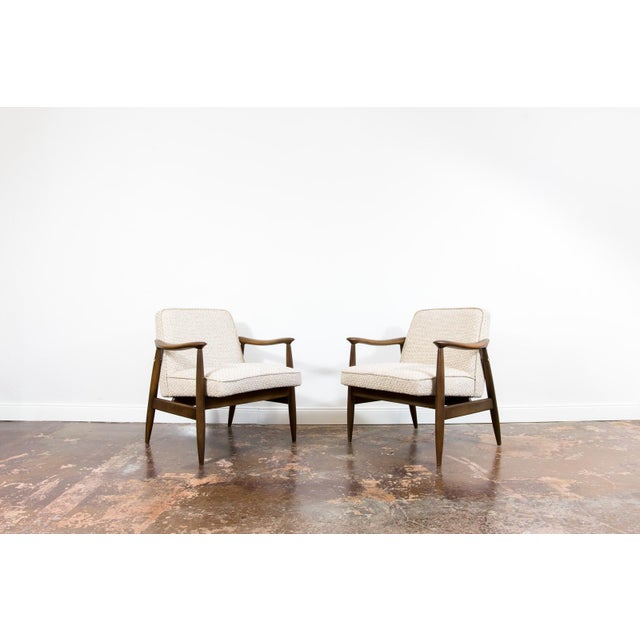 A pair of armchairs "gfm87," designed by juliusz kędziorek and produced in the gościcińska furniture factory in the 1960s,...
