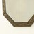 Decorative octagonal mirror with a brass frame. This mirror features faceted glass and hangs from a decorative chain. It...