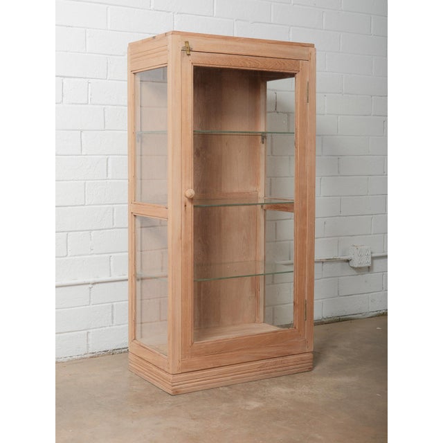 This vintage wooden and glass display cabinet offers a beautifully simple, timeworn charm that reflects decades of use and...