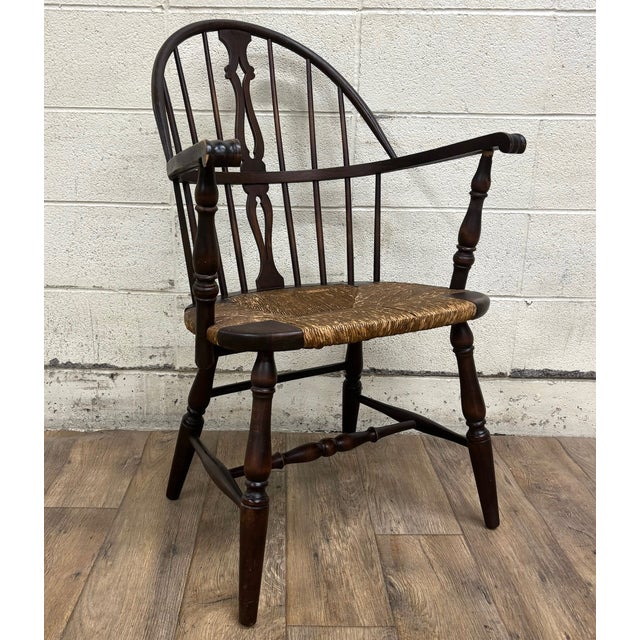 This is a beautiful vintage, possibly antique, sack back rush seat Windsor arm chair. Beautifully constructed, with turned...
