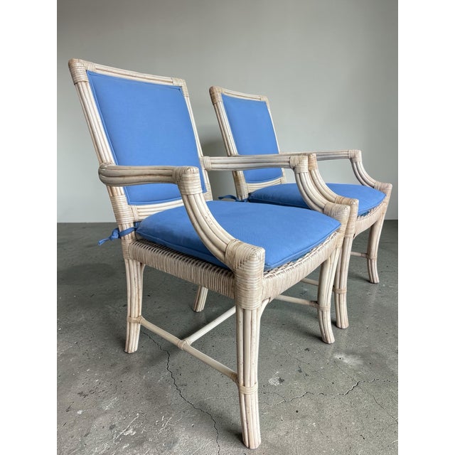 Pair of Lane Venture rattan armchairs from the Excursions collection, featuring a refined lattice back design and light...