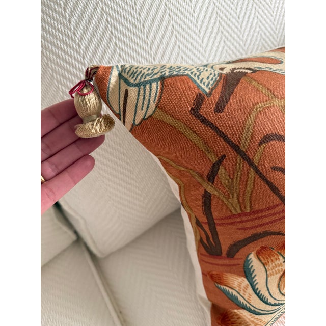 A serene botanical scene unfolds across this decorative lumbar pillow in rich lacquer orange-red and ivory. The center...