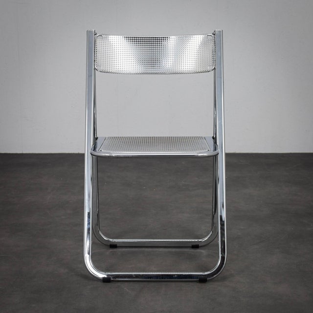 A sleek folding chair produced by arrben during the 1980s. The combination of perforated chromed metal and clean geometric...
