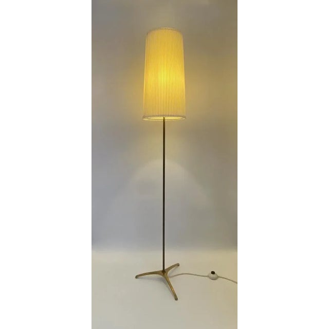 A floor lamp *Original mid century floor lamp *with pleated umbrella *with nice brass details *Three -footed brass *Very...