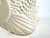 A striking mid-century Japanese ceramic vase modeled as a sculptural angelfish, finished entirely in a warm ivory-white...
