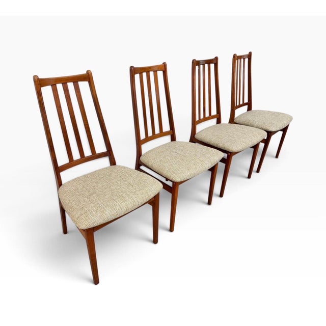 A stylish set of four vintage Danish Modern teak dining chairs, circa 1970s. Featuring tall, slender backs with vertical...