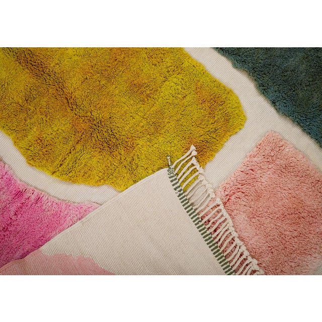 Vibrant hand-knotted wool rug showcasing bold blocks of Pesto Green, Rain Forest, Yellow, and Blush Pink on an Ivory base....