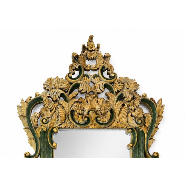This Baroque-style wall mirror features a frame crafted with exquisite hand-carved details using high-relief openwork...