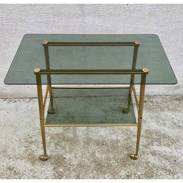 Charming little rolling serving cart from the 1970s in excellent condition. Gold color with a glass top. Dimensions:...