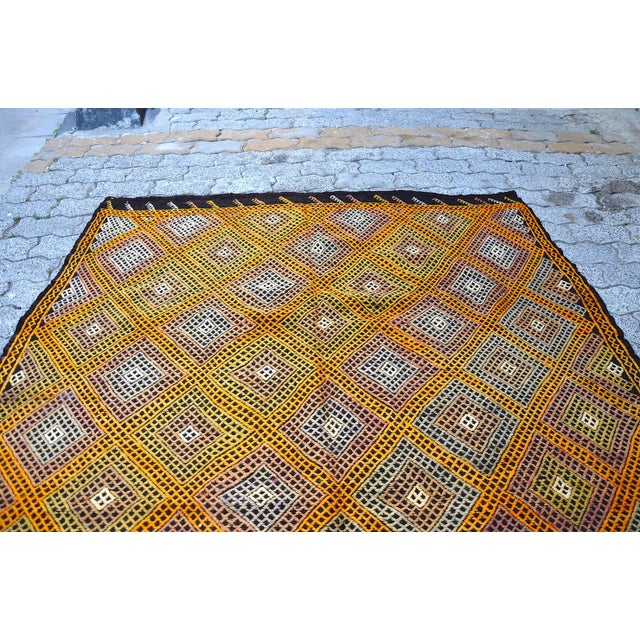 This is a vintage Turkish Anatolian kilim rug from the 1960s. The piece was hand-woven.
