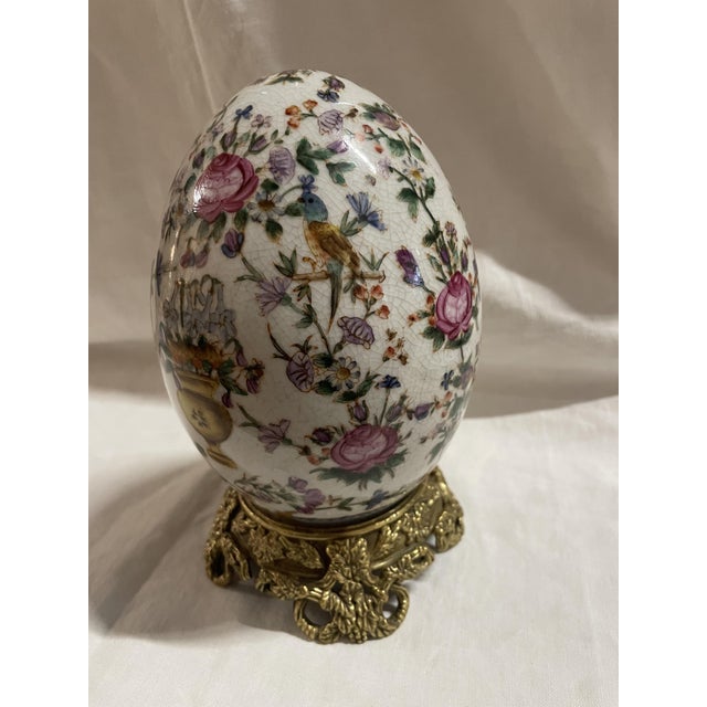 Crackle-glazed porcelain egg on a gilt bronze base