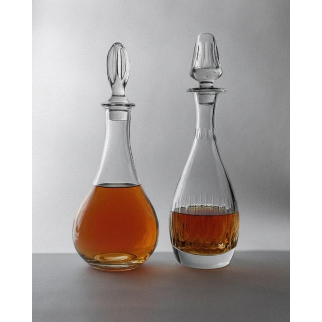 This vintage crystal glass decanter set from the 1980s includes two large, beautifully balanced pieces in matching yet...