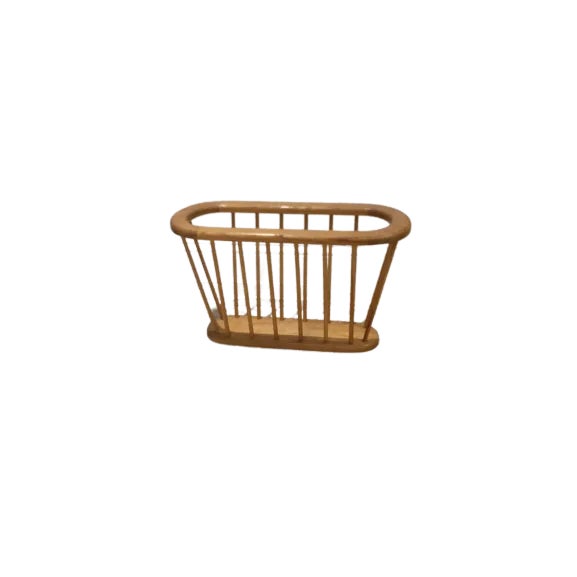 Mid-Century wood magazine rack similar in style to the Arthur Umanoff magazine rack. It is a light color and in great...