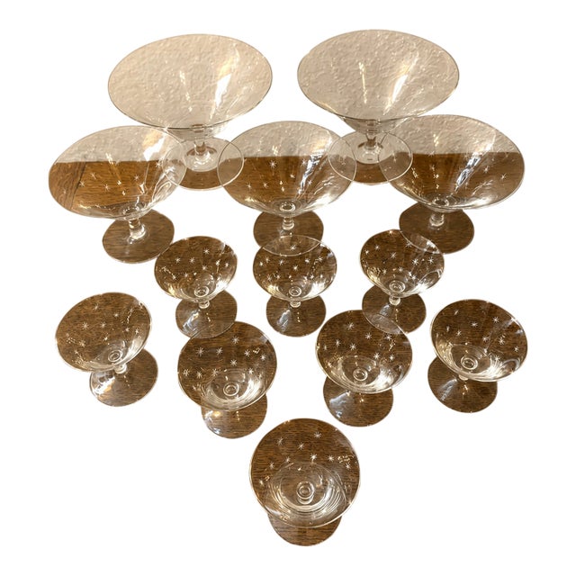 RICHARD BRENDON'S THIRTEEN HAND-ENGRAVED CRYSTAL CHAMPAGNE SAUCERS AND LIQUEUR GLASSES WITH STARS DESIGN. Set of 12....