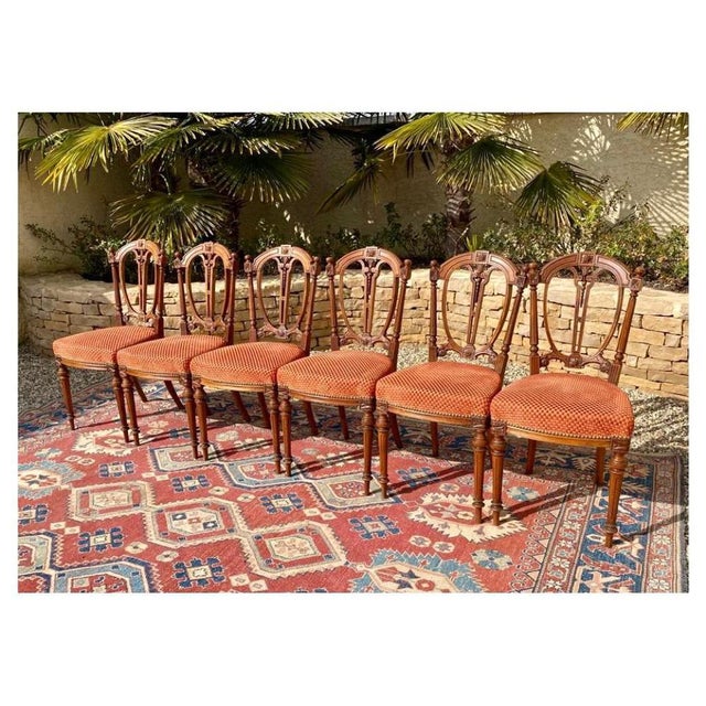 Suite of 6 Louis XVI style walnut chairs. Seats covered with an orange diamond fabric in very good condition and very...