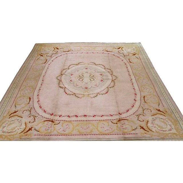 ACTUAL SIZE: 10’9″ x 13’8″ PRIMARY COLOR: Pink / Ivory AGE: Antique ORIGIN: Europe MATERIALS: Wool FOUNDATION: Cotton...