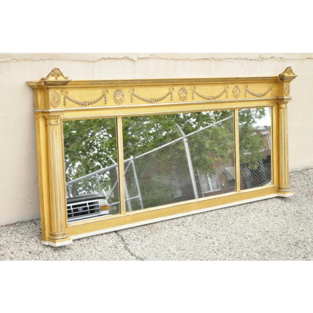 Antique Large 83" Victorian Gold Giltwood Figural Triple Overmantle Mirror. Item features triple glass mirror, faces and...