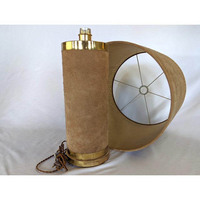 Dims.: 6" Diameter (Base) x 33"OAH Shade: 18" Diameter x 16"H Origin: France Circa: 1970's A suede table lamp from the 1970s.