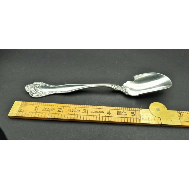 This marvelous antique cheese scoop is created in gorgeous sterling silver and was made by International Silver Co. of...