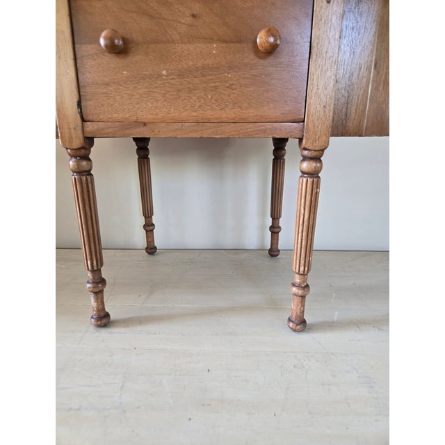 This is a Martha Washington style sewing cabinet with it’s distinctive oval shape with hinged side flaps that open to...