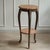 This two-tiered gueridon in the Louis XV style combines cast brass legs with reddish-veined marble and stylistically dates...