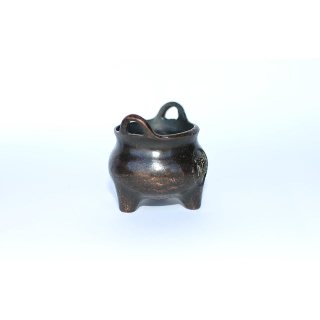 A charming and rare trio of Late 20th Century Chinese miniature bronze incense burners, each displaying a distinct...