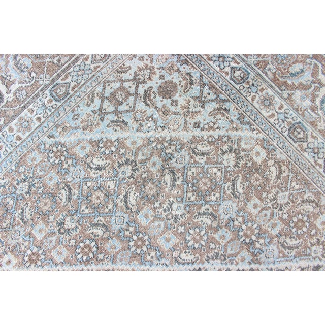 Measures: 8'6 x 11'7 Tan background Persian Tabriz rug with free flowing floral design. Keivan Woven Arts rug R20-0603,...