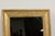 A French rectangular mirror from the 19th century painted with distressed golden tones and with molded accents. Embodying...