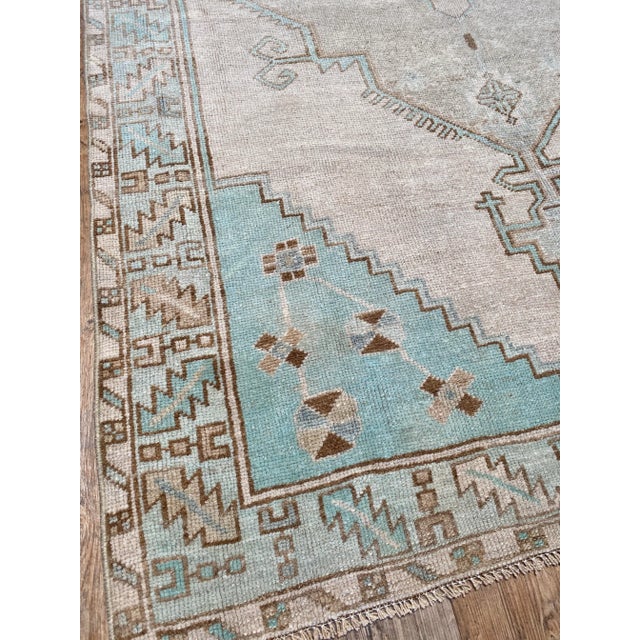 A beautiful vintage Oushak runner. This runner offers a gray palette with brown and blue accents.