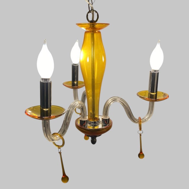 This gorgeous Murano chandelier will add a pop of color to any room. Mid century modern, it’s adds a classic look....