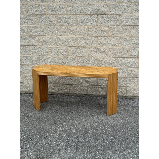Vintage console table executed in split reed, with a geometric parquet-style top composed of angled reed segments.