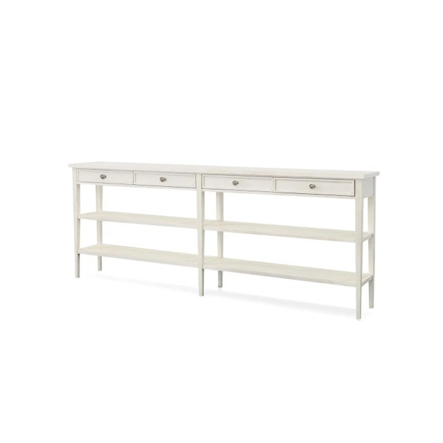 An off-white finish on mahogany solids and veneers. Four drawers with pewter finish hardware above two open shelves. Tip...