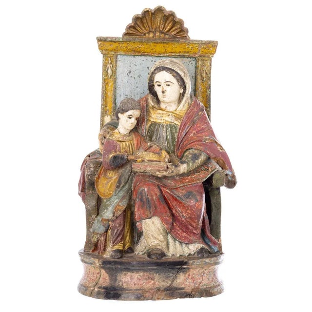 Indo-Portuguese sculpture, from the 17th century, in polychrome wood. The figure is represented sitting on a high-backed...