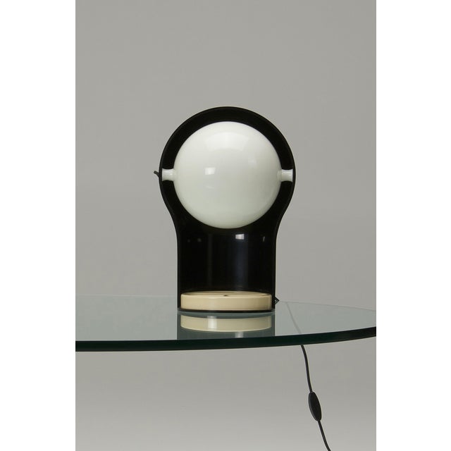 A Telegono table lamp, designed by Vico Magistretti for Artemide in 1969. The combination of the semi-spherical diffuser...