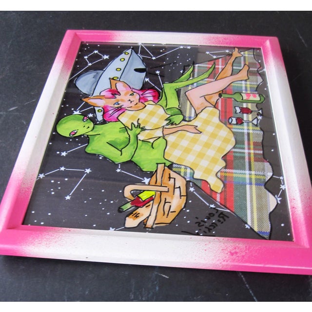 This artwork depicts an otherworldly picnic scene where an alien figure interacts playfully with a woman, surrounded by a...