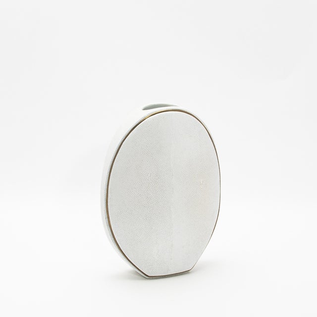 The elegant Oval Vase by R&Y Augousti, crafted in shagreen and accented with brass, is a sophisticated fusion of organic...