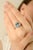 This elegant signet ring is crafted in solid 925 sterling silver and features a stunning oval-cut blue topaz gemstone at...