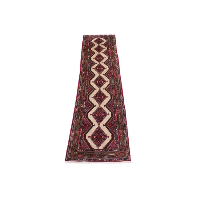 Beautiful vintage tribal runner rug featuring a classic geometric diamond medallion design on an ivory field with rich red...